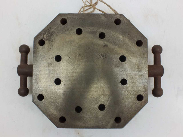 Top surface of octagonal steel resistance heating block showing option holes and side handles – overhead view