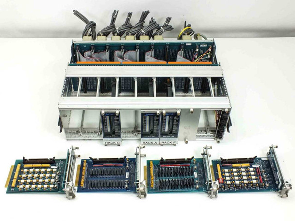 Overhead view of chassis with cards removed showing backplane, and four 24-channel I/O cards laid out below — card PCBs visible