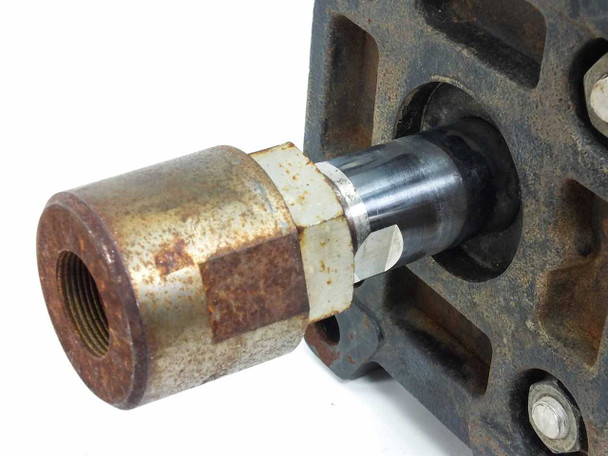 SMC CDA1FN100-G0547-25 second angle of threaded rod end and flange mount showing rust and wear on hex fitting