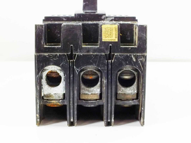 Unbranded 3-pole circuit breaker — bottom load-side lug terminals view with small yellow rating label partially visible