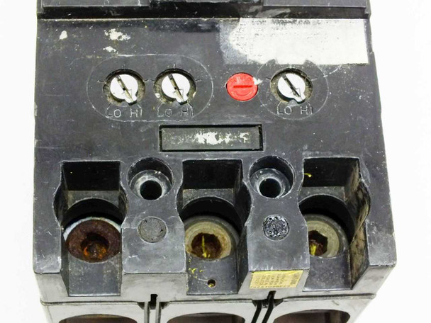 Unbranded 3-pole MCCB — top line-side view showing three Lo/Hi trip adjustment screws and red reset button