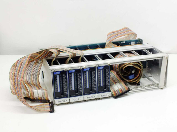 First Light Technology 4-bank I/O chassis front-left angle view showing 4 populated card slots labeled Rack A–D with ribbon cables attached