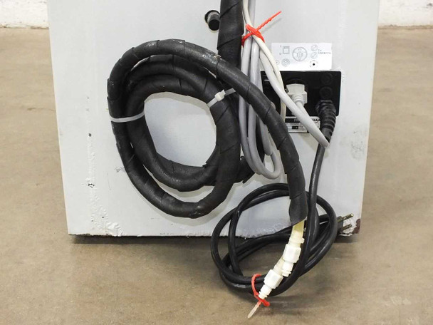 Rear lower panel of Haake K chiller unit showing coiled refrigerant/fluid tubing and slight scuffing on white cabinet