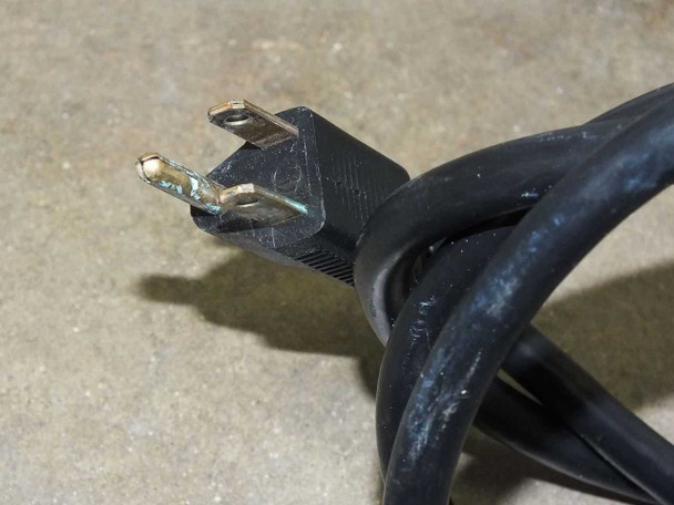 NEMA 5-15P power cord plug closeup showing standard 3-prong US plug