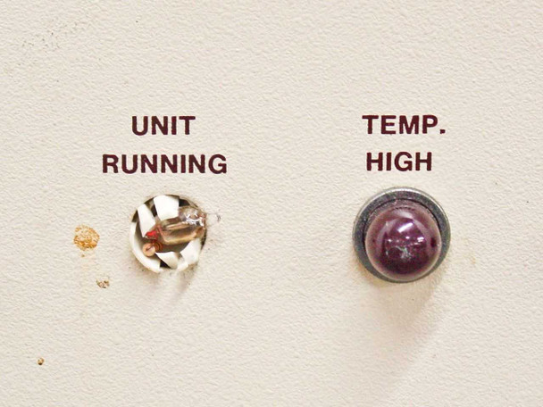 Close-up of Unit Running indicator socket (lamp missing) and Temp High indicator light on front panel