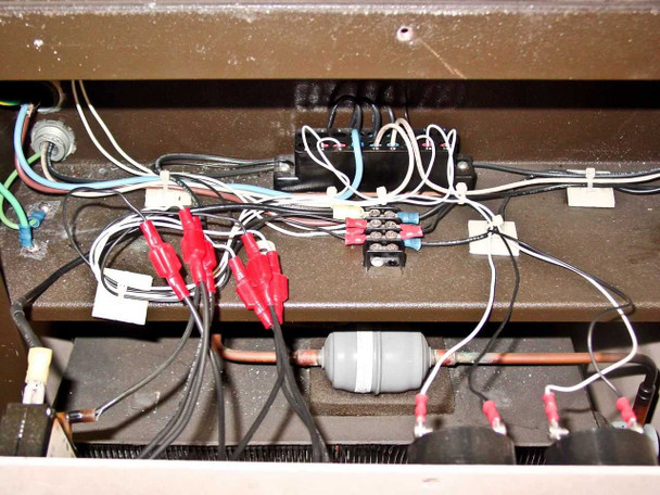 Interior view showing wiring harness, terminal blocks, capacitor, and copper refrigerant lines