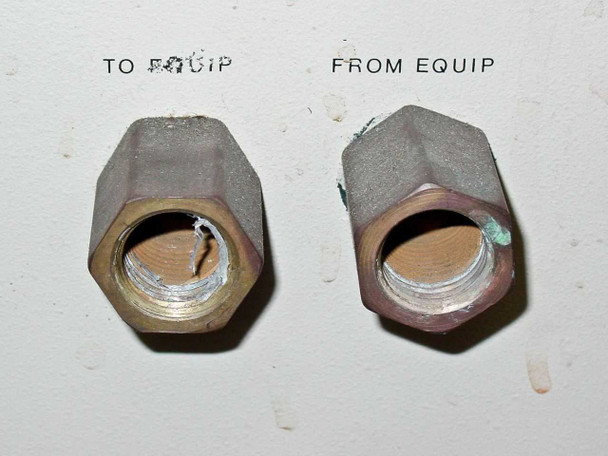 Rear panel close-up of To Equip and From Equip coolant outlet fittings with visible thread damage and oxidation