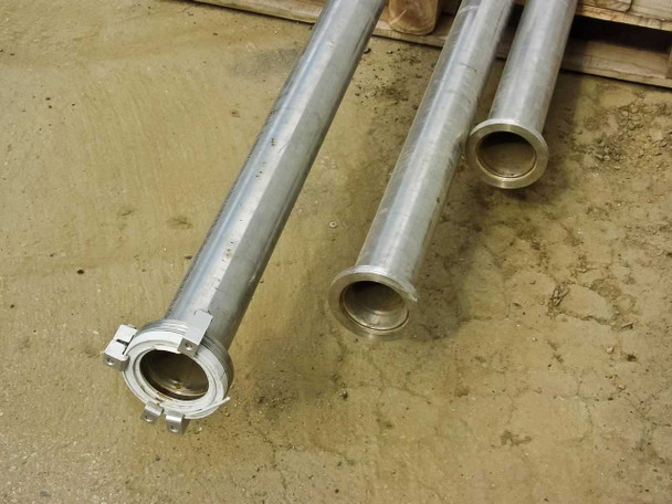 Close-up of stainless steel pipe ends showing flanged tri-clamp style fittings and 2-3/4 inch inside diameter