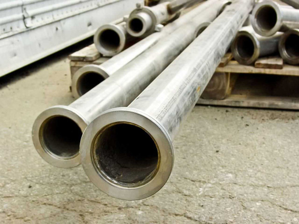 Ends of straight stainless steel pipe sections showing 2-3/4 inch bore and machined flange faces