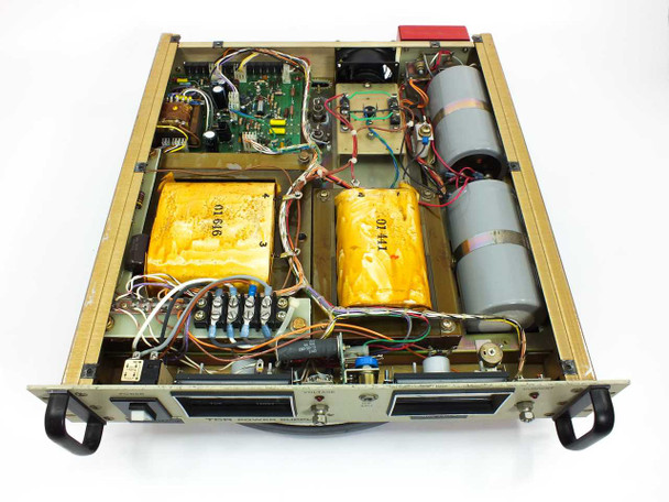 EMI TCR 150S7 DC Power Supply interior top view — two yellow potted transformers, control PCB, filter capacitor bank, and wiring