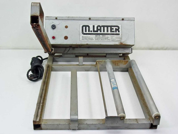 M. Latter Model 16 Shrink Wrap Heat Sealer – front 3/4 view showing control box with indicator lights, raised pivot sealing arm, aluminum roller on frame, and power cord