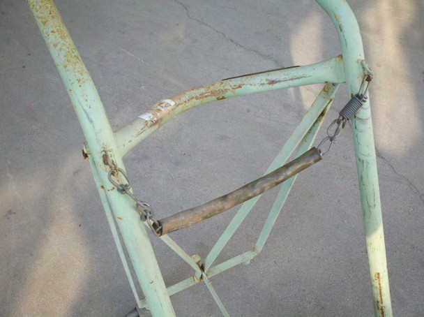 Harper Trucks hand truck close-up of upper frame and chain restraint bar showing rust and wear on cross-member and bungee/chain hooks