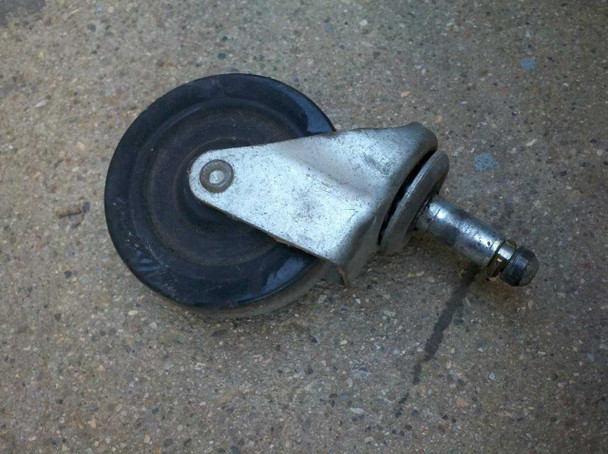 Detached 3-inch push-in stem caster with rubber wheel and metal swivel bracket — replacement caster reference for missing unit