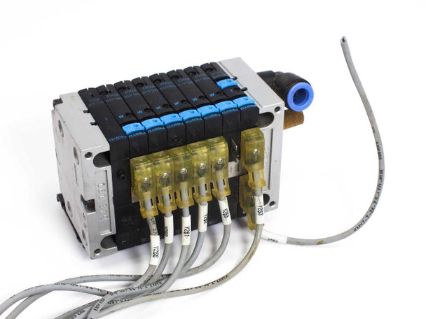 Festo solenoid valve manifold rear view showing yellow wiring terminal connectors and gray cable leads