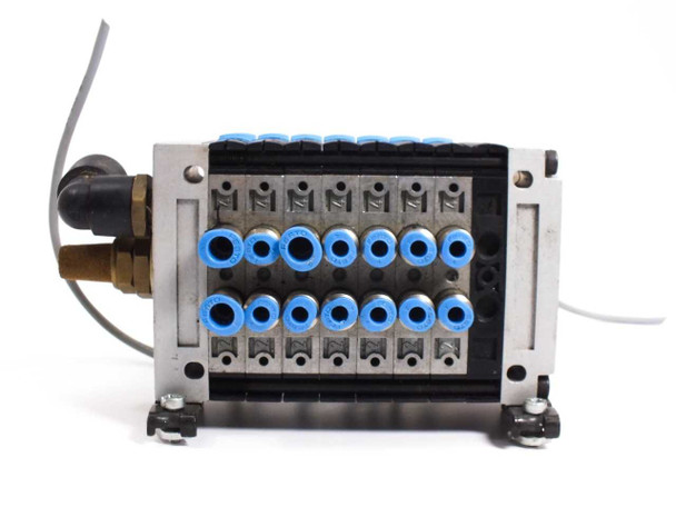Festo valve manifold front face view showing two rows of blue push-in pneumatic fittings and brass port fittings
