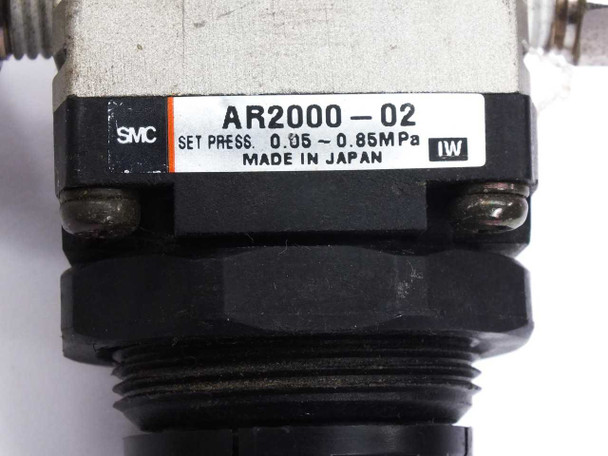 SMC AR2000-02 label close-up — showing model number, set pressure 0.05–0.85 MPa, SMC branding, and Made in Japan marking