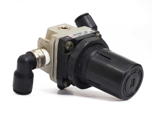 SMC AR2000-02 modular pressure regulator — front three-quarter view showing aluminum valve body, black plastic adjustment knob, and angled push-in fittings
