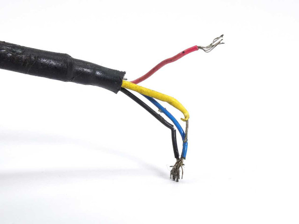 Close-up of HBM SP4EC3 load cell cable end showing four exposed conductors — black, red, yellow, and blue — with damaged wire jacket