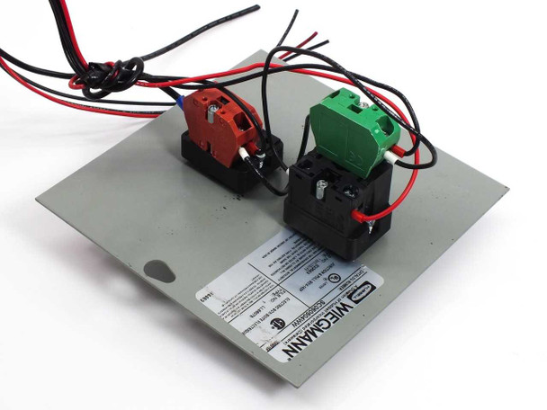 Wiegmann mounting plate close-up with red and green push button assemblies and Wiegmann label visible, wiring leads shown