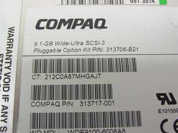 Compaq 313717-001 hard drive label close-up showing 9.1GB Wide Ultra SCSI-3, Compaq P/N 313717-001, Option Kit P/N 313706-B21, and WD MDL WDE9100-6008A8
