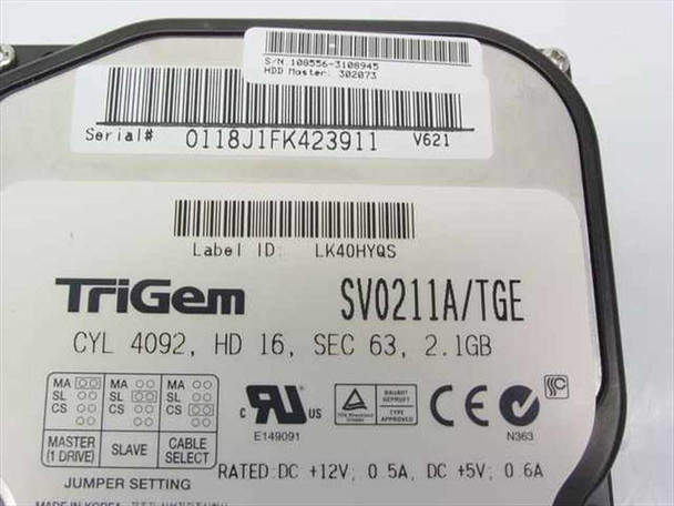 TriGem SV0211A/TGE 2.1GB IDE hard drive — top label view showing model number, CYL/HD/SEC specs, jumper diagram, and voltage ratings