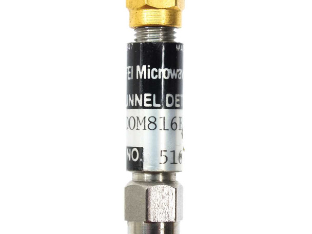 FEI Microwave DOM816BRS Tunnel Detector label closeup showing model number DOM816BRS and partial serial number