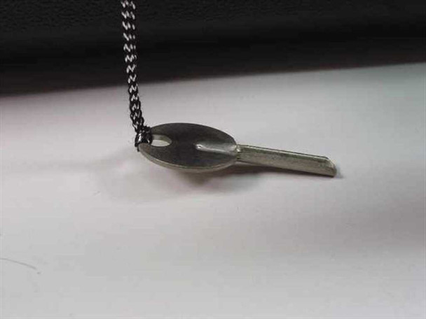 Close-up of the carry case lock key on a metal chain