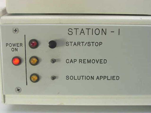 Close-up of Station 1 front panel showing Power On indicator, Start/Stop, Cap Removed, and Solution Applied indicator lights with missing button caps
