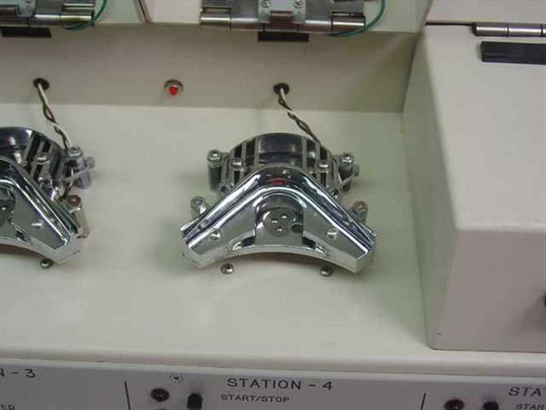 Interior top-down view of Stations 3 and 4 showing chrome electrode fixture mechanisms mounted in the station bays