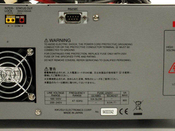 Kikusui TOS9201 AC/DC Hipot Tester front panel with kV analog meter, LCD display, and high-voltage output terminals — top view with test leads draped over unit