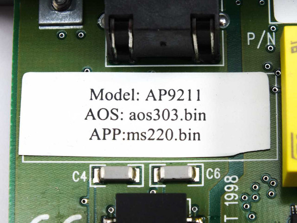 Close-up of APC AP9211 board label showing Model AP9211, AOS firmware aos303.bin, and APP firmware ms220.bin