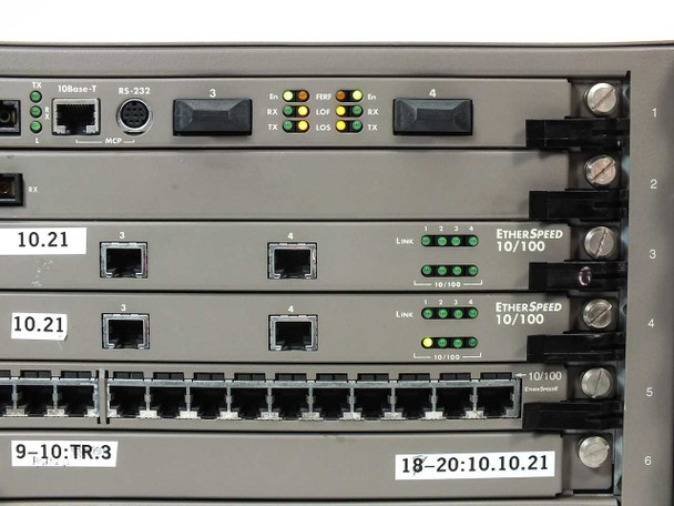 Close-up of middle card slots showing ATM Speed/155 NC management ports (10Base-T, RS-232/MCP), two EtherSpeed 10/100 boards with RJ45 ports and green Link LEDs lit, and 24-port Token Ring trunk row at bottom