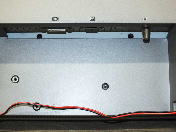 Dell W3000 bottom connection bay — DVI-style connector port and coaxial/antenna F-connector port visible, along with speaker wiring routed along the base