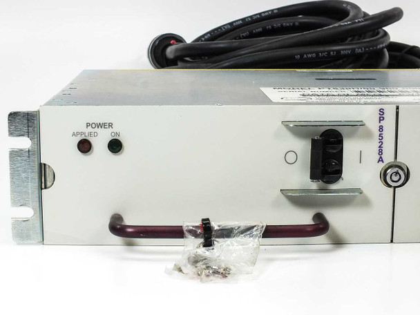 SP8528A module close-up showing front panel with POWER APPLIED and POWER ON indicator LEDs, IEC C14 inlet, and included hardware bag with keys