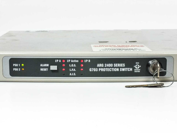 ARG 2400 Series G.703 Protection Switch front panel close-up showing PSU 1, PSU 2, Alarm, Reset, I/P A, I/P Active, I/P B, LOS, LFA, AIS indicators and key switch