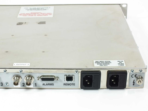 ARG 2400 Series G.703 Protection Switch rear panel close-up showing dual IEC AC power inlets, remote RJ-45 port, alarms connector, and dual supply warning label