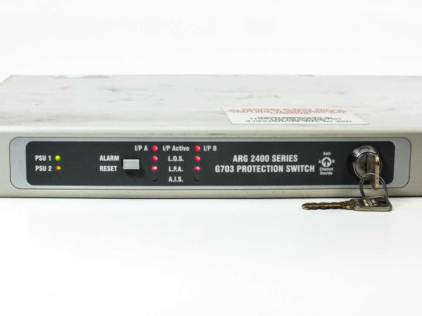ARG 2400 Series G.703 Protection Switch front panel close-up showing PSU 1/PSU 2 indicators, ALARM, RESET button, L.O.S., L.F.A., A.I.S. LEDs, I/P A and I/P B active indicators, and keyswitch with keys