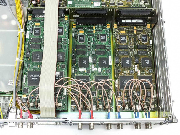 Pegasus XT interior detail showing interface board with multiple ICs, ribbon cable connections, and yellow signal wiring