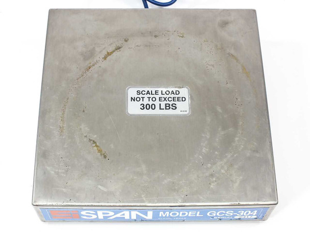 SPAN GCS-304 scale platform top surface showing 300 LBS max load sticker and circular wear mark from cylinder use