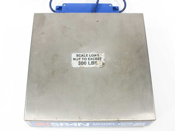 SPAN GCS-304 top-down view of stainless steel scale platform with 'Scale Load Not to Exceed 300 LBS' warning label affixed to surface