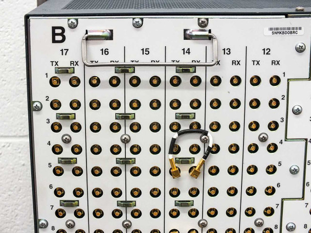 Cisco ONS 15454 rear backplane closeup of B-side slots 12–17 showing BNC TX/RX connectors in rows 1–8, with a small cable jumper visible at slot 14