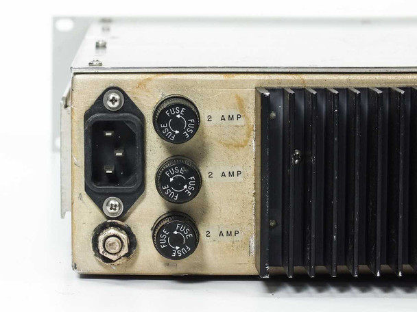 Miteq 6107 rear panel left section — close-up of IEC AC power inlet and three 2-AMP fuse holders with partial view of heat sink fins