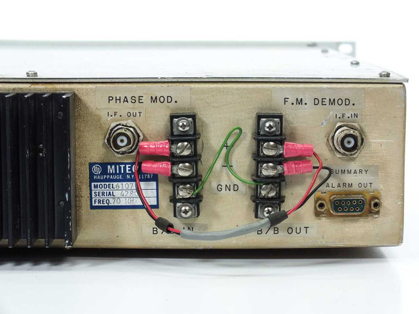 Miteq 6107 rear panel full view — Phase Mod. I.F. OUT BNC, F.M. Demod. I.F. IN BNC, terminal blocks for B/B IN and B/B OUT, GND lug, Summary Alarm Out D-sub connector, and Miteq identification label showing Model 6107, Serial 42507, Freq. 70 MHz