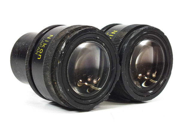 Nikon CFUW 10x eyepiece pair — angled bottom view showing lens elements and Nikon Japan markings