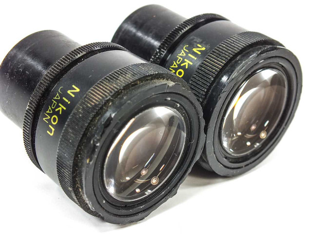 Nikon CFUW 10x eyepiece pair — angled side view showing knurled body, lens elements, and Nikon Japan text