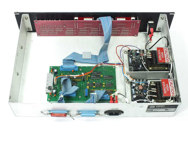 Varian VJW1454R1 interior view — main PCB with ribbon cables, red backplane board, internal power components with CAUTION HIGH VOLTAGE labels