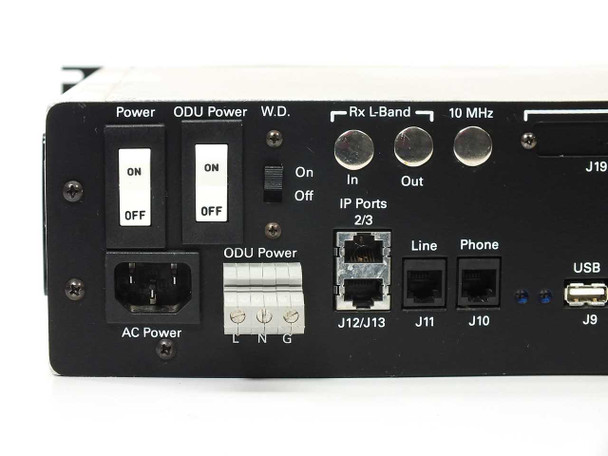 Americom AST3100 rear panel left section showing Power and ODU Power switches, WD switch, AC power IEC inlet, ODU Power terminal, Rx L-Band In/Out BNC, 10 MHz BNC, IP Ports 2/3, Line, Phone, and USB connectors