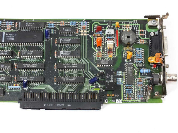 Apple 820-0207-A close-up of bracket end — Rev K marking, NPC23407 and 74-series logic ICs, DB-15 AUI and BNC ports with bracket wear