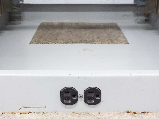 Close-up of two built-in NEMA power outlets mounted at the base of the rackmount cabinet