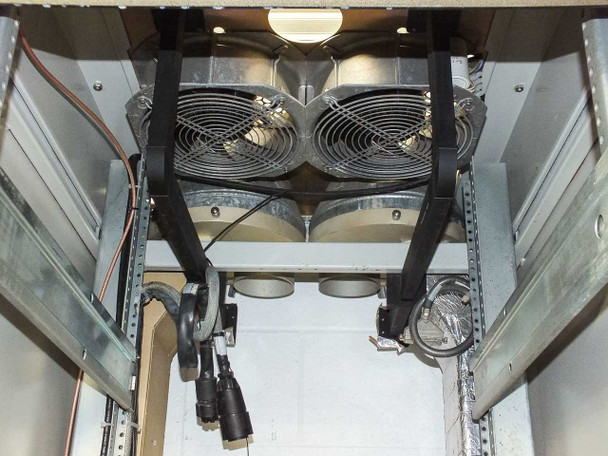 Xicom Technology rack cabinet — top interior view showing dual large cooling fans mounted in fan tray with braided power cables